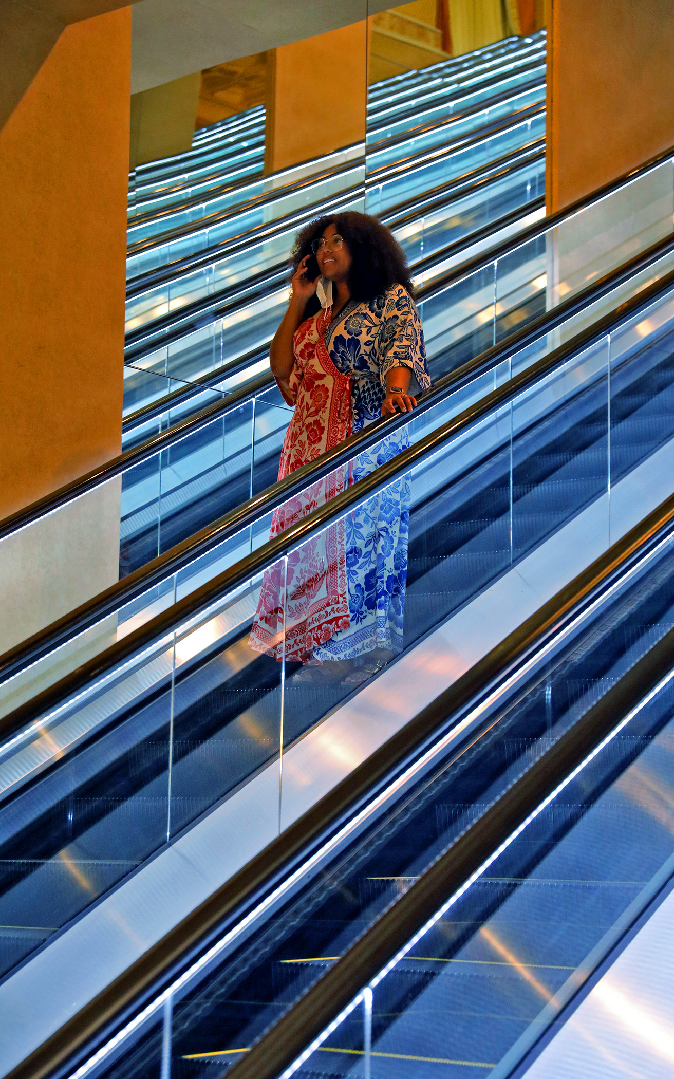 Ayana Gibbs-Okoya takes the escalators down from the convention center before the NABJ/NAHJ 2022 Convention gets underway in Las Vegas, Nev., on Tuesday, August 2, 2022.