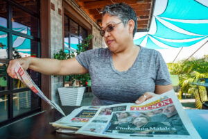 Blanca Carillo holds up to read a La Estrella newspaper